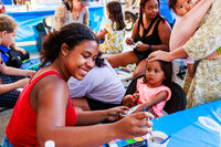 Photo: Volunteers at the North City Neighborhood Association booth provided free face painting.