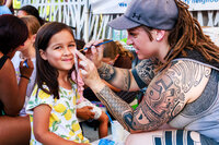 Photo: Volunteers at the North City Neighborhood Association booth provided free face painting.