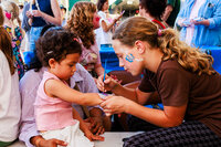 Photo: Volunteers at the North City Neighborhood Association booth provided free face painting.